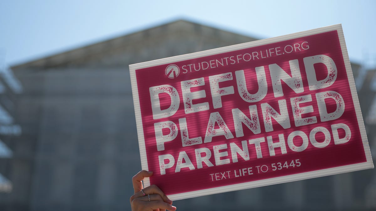 Protestors holding "Defund Planned Parenthood" signs stand outside of the U.S. Supreme Court on June 20, 2025 in Washington, DC.