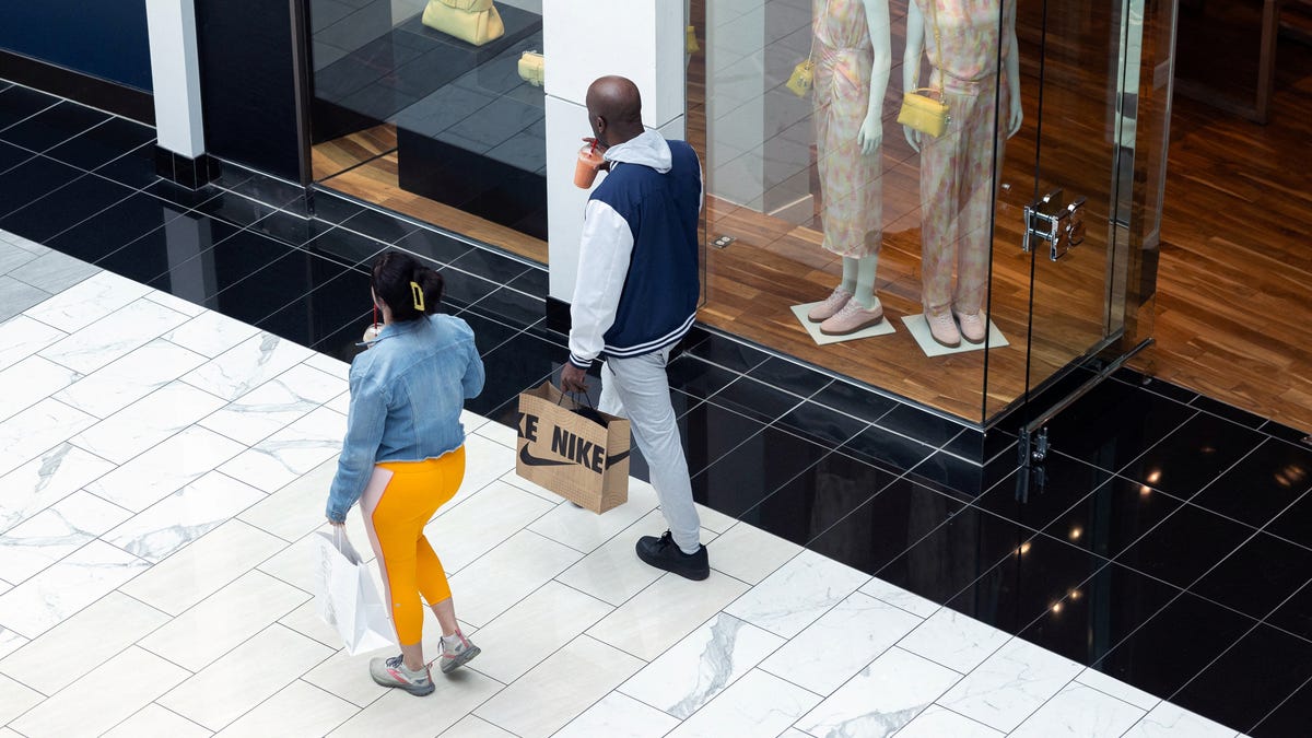 A shopper holds a Nike shopping bag, as global markets brace for a hit to trade and growth caused by President Donald Trump's decision to impose import tariffs on dozens of countries, in the King of Prussia Mall in King of Prussia, Pennsylvania, on April 3, 2025.