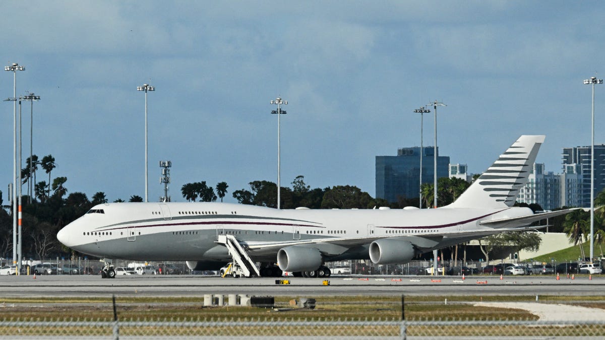 A Qatari Boeing 747 sits on the tarmac of Palm Beach International airport after President Donald Trump toured the aircraft on February 15, 2025. Donald Trump plans to accept a luxury Boeing jet from the Qatari royal family for use as Air Force One.