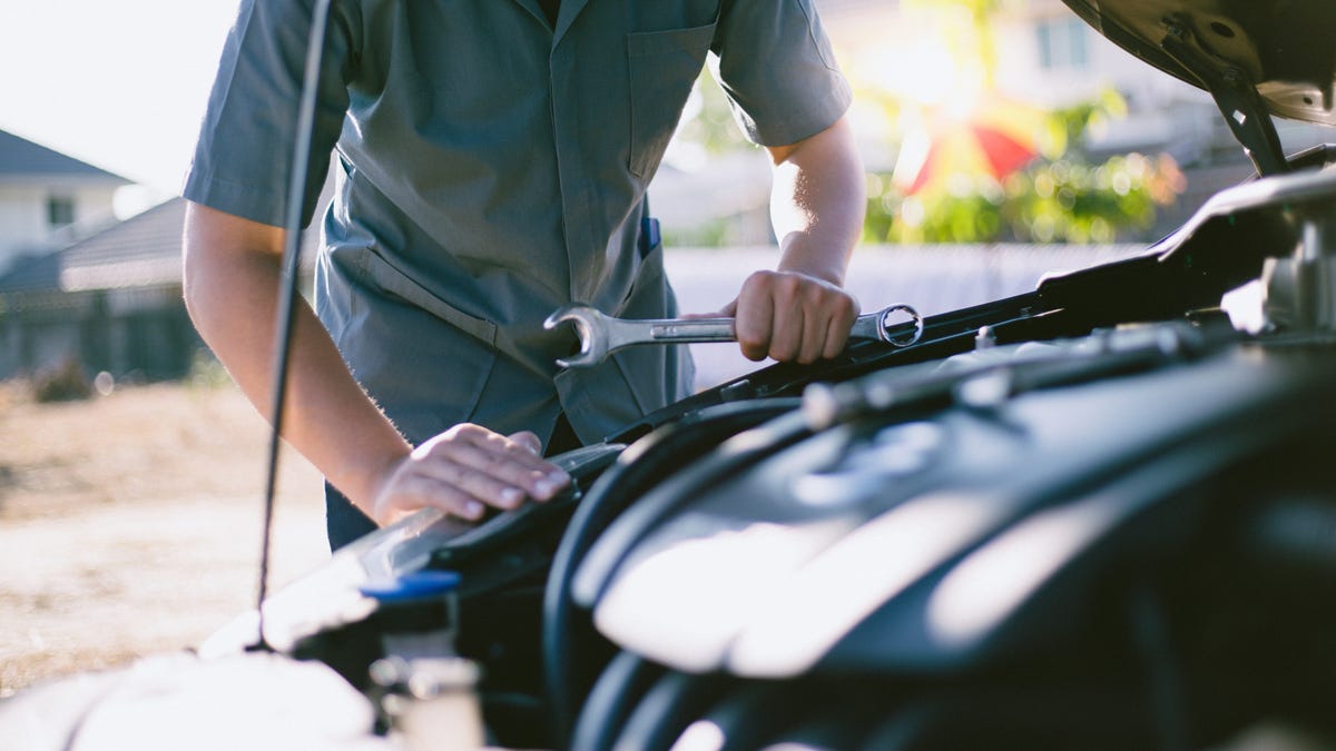 Car mechanic has checked the condition of the engine in wrench, Car repair service concept.