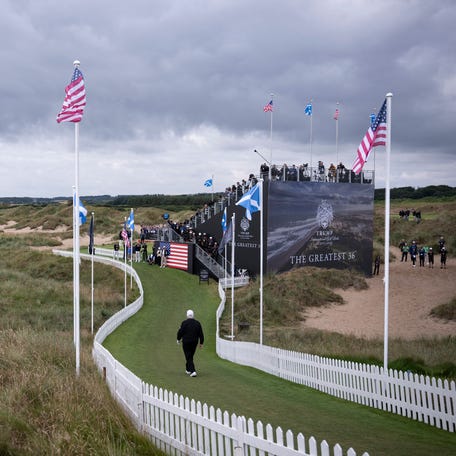 President Donald Trump, walks to the first tee to officially open the Trump International Golf Links course in Balmedie, Aberdeenshire, north east Scotland on July 29, 2025. Trump is visiting Scotland in a trip that's part-vacation, part-work, as he stayed at his Trump Turnberry golf course, followed by Trump International Golf Links in Aberdeenshire, between July 25 to 29.