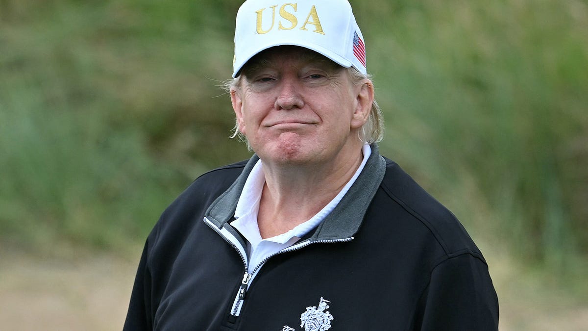President Donald Trump reacts after playing from the first tee to officially open the Trump International Golf Links course in Scotland on July 29, 2025.