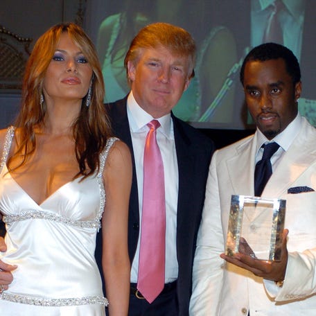Sean Combs (right)accepts an award from the Rush Philanthropic Foundation from Donald Trump and his wife Melania Trump (left) at Mar-A-Lago Club in Palm Beach, Florida on March 11, 2005.