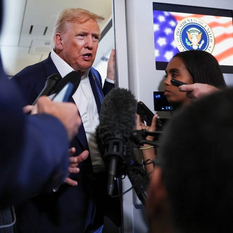 U.S. President Donald Trump speaks to members of the media on board Air Force One en route from Scotland, Britain, to Joint Base Andrews, Maryland, U.S., July 29, 2025.