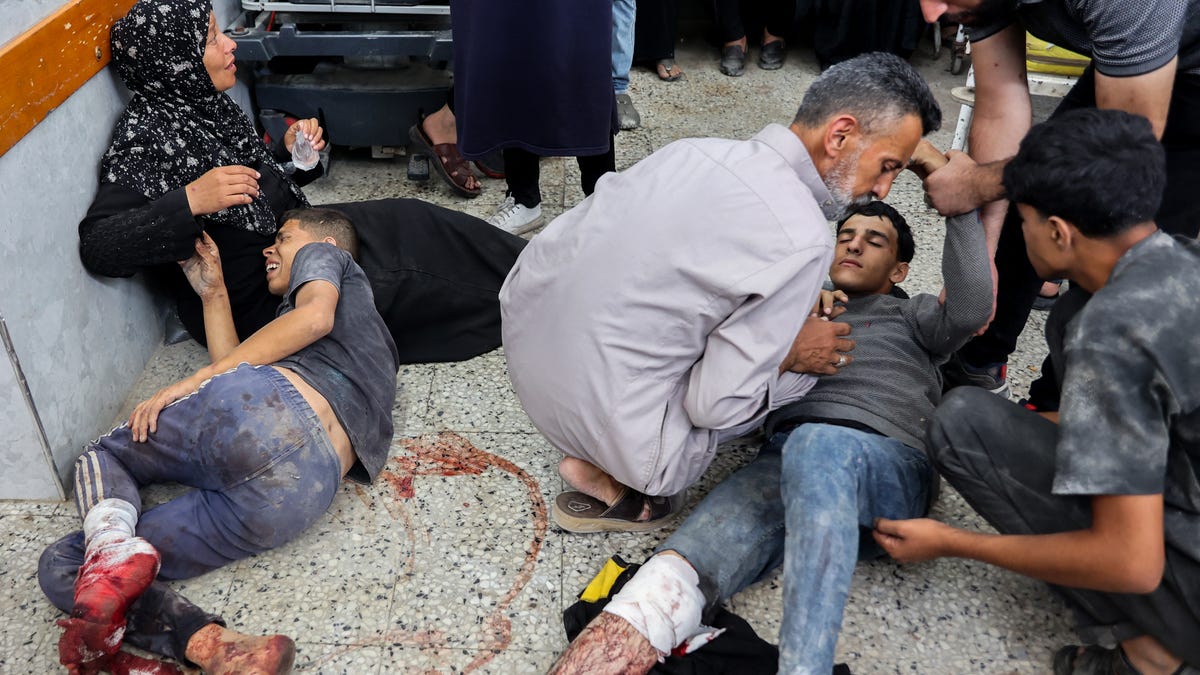 A member of the medical staff tends to people reportedly wounded while waiting for aid delivery, at al-Shifa hospital in Gaza City, on July 3, 2025, amid the ongoing conflict between Israel and the Palestinian Hamas militant group.