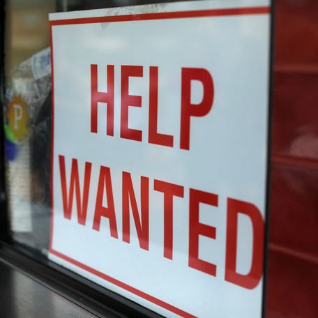 A help wanted sign is posted at a taco stand in Solana Beach, California, July 17, 2017.