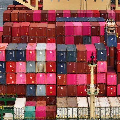 Shipping containers are stacked on a ship at a port in Oakland, California, on Aug. 1, 2025.
