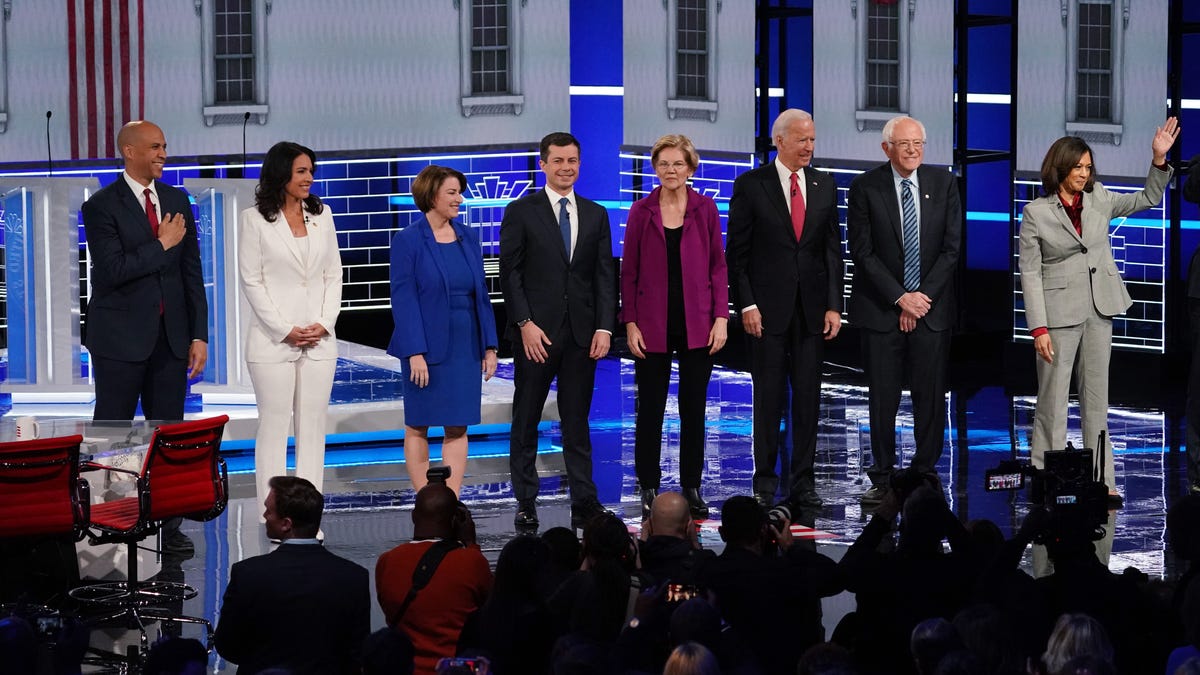 Democratic U.S. presidential candidates Senator Cory Booker, Rep. Tulsi Gabbard, Senator Amy Klobuchar, South Bend Mayor Pete Buttigieg, Senator Elizabeth Warren, former Vice President Joe Biden, Senator Bernie Sanders and Senator Kamala Harris pose at the start of their fifth 2020 campaign debate at the Tyler Perry Studios in Atlanta, Georgia, on November 20, 2019.