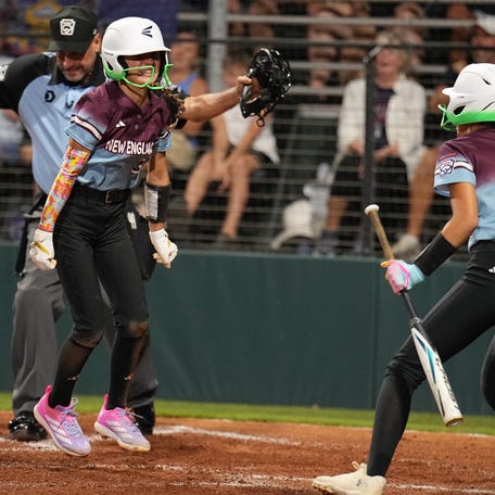 Connecticut's Michaela Mascari (No. 3) is called safe at the plate in the sixth inning while teammate Maeve McGowan (No. 4) watches at the 2025 Little League Softball World Series in Greenville, North Carolina