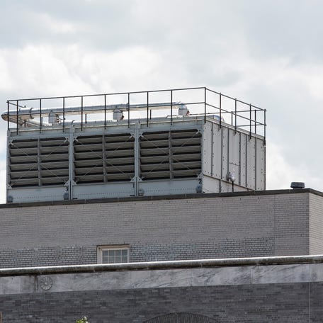 A water cooling tower found to have traces of Legionella bacteria, which may have helped cause the recent outbreak of Legionnaires' disease in the Bronx, is seen atop a U.S. Post Office building in New York City.