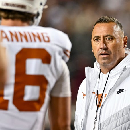Nov 30, 2024; College Station, Texas, USA; Texas Longhorns head coach Steve Sarkisian speaks with quarterback Arch Manning (16) during warm ups against the Texas A&M Aggies at Kyle Field. Mandatory Credit: Maria Lysaker-Imagn Images