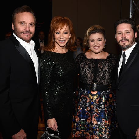 Narvel Blackstock, from left, singers Reba McEntire and Kelly Clarkson, and Clarkson's then-husband Brandon Blackstock attend Muhammad Ali's Celebrity Fight Night XXI at the JW Marriott Phoenix Desert Ridge Resort & Spa in Phoenix on March 28, 2015.