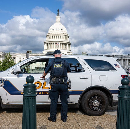 An US Capitol Police office enters his car parked on the side walk near the US Capitol in Washington, DC, on August 8, 2025. US President Donald Trump ordered on August 7 to use federal law enforcement in Washington, DC to combat crime. (Photo by Jim WATSON / AFP) (Photo by JIM WATSON/AFP via Getty Images)