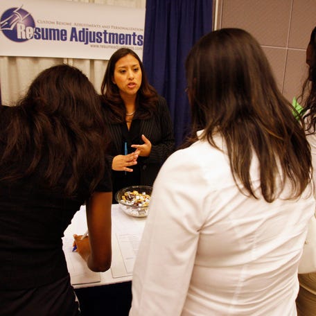 People queue to receive advice about their job resumes at a career fair in Los Angeles.