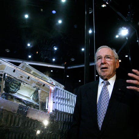 Astronaut Jim Lovell speaks in front of the Gemini 12 during the unveiling of the "Shoot for the Moon" exhibition at the Adler Planetarium in Chicago on Nov. 9, 2006.