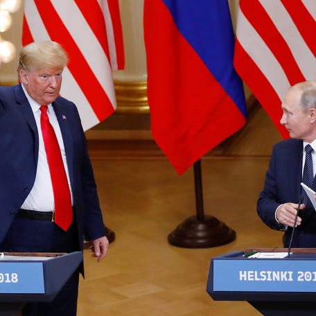 U.S. President Donald Trump and Russian President Vladimir Putin react at the end of the joint news conference after their meeting in Helsinki, Finland, July 16, 2018.