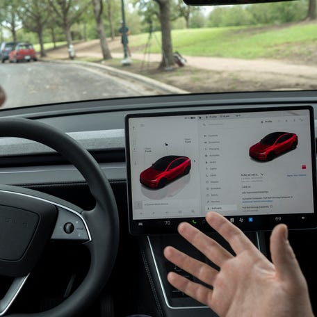 Arthur Maltin, a test driver with The Dawn Project, performs a safety test on a self-driving feature in a Tesla Model Y during a protest against Tesla robotaxis, ahead of the Tesla robotaxis' official services in Austin, Texas, U.S., June 12, 2025.