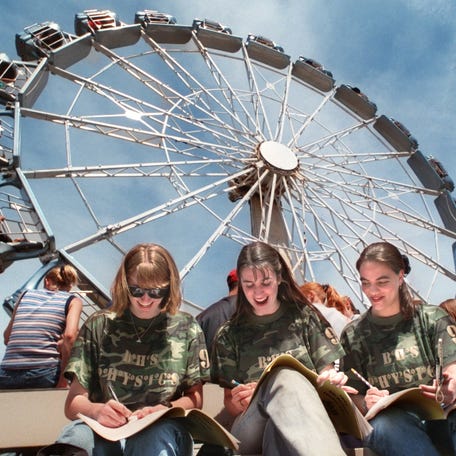 (L to R) Seniors Elizabeth Markwick, Carrie Leonard and Mary Janosov of Boardman High School in Youngstown, Ohio try to finish a physics problem pertaining to the centrifugal force and the G force of the "Silver Bullet" ride at Geauga Lake on a Friday afternoon in 1997.