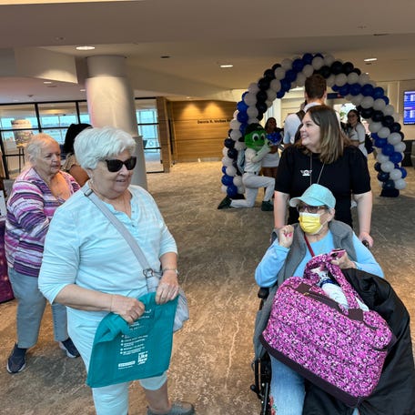 Rosemarie Shepherd, pictured in the wheelchair, of Montague, New Jersey, is greeted by friends Louise Noroian and Tillie Bell of St. Augustine as she is wheeled into the passenger terminal at Daytona Beach International Airport on Thursday, Nov. 14, 2024.