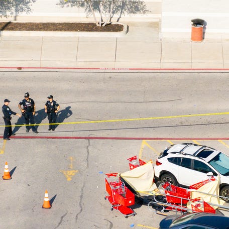 In an aerial view, law enforcement officers stand guard on the grounds of a Target store on August 11, 2025 in Austin, Texas. 3 people have died after a gunman opened fire in the parking lot of a Target store in north Austin.