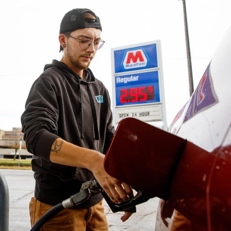 Ezra Newman of South Bend pumps gas into his car at the Marathon gas station on East Colfax Avenue on Thursday, Oct. 31, 2024, in South Bend.