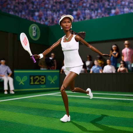 The Venus Williams doll wears the uniform from her 2007 Wimbledon win, marking the win that made her a five-time champion and the first woman in tennis to  earn equal prize money at a top-level tournament.