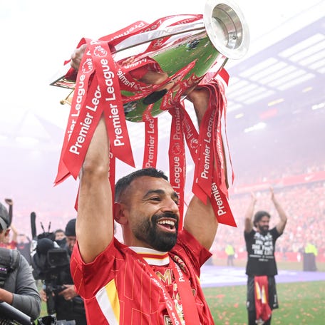 Mohamed Salah lifts the Premier League trophy to the fans after the match between Liverpool FC and Crystal Palace FC at Anfield in Liverpool, England, on May 25, 2025.