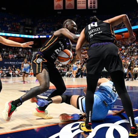 Aug 13, 2025; Uncasville, Connecticut, USA; Connecticut Sun guard Saniya Rivers (22) tries to step in as guard Bria Hartley (14) stands over Chicago Sky guard Rebecca Allen (9) during the first half at Mohegan Sun Arena. Mandatory Credit: Eric Canha-Imagn Images