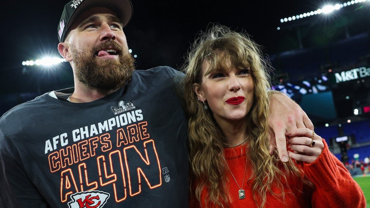 Travis Kelce #87 of the Kansas City Chiefs (L) celebrates with Taylor Swift after defeating the Baltimore Ravens in the AFC Championship Game at M&T Bank Stadium on January 28, 2024 in Baltimore, Maryland.