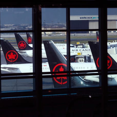 Tails of Air Canada planes are seen at Pearson International Airport on August 14, 2025 in Toronto, Canada. With a looming flight attendant strike, the company announced that all flights will be paused by early Saturday morning unless a deal is reached with the Canadian Union of Public Employees. (Photo by Cole Burston/Getty Images)