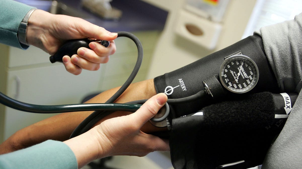 Dr. Elizabeth Maziarka reads a blood pressure gauge during an examination of patient June Mendez at the Codman Square Health Center April 11, 2006 in Dorchester, Massachusetts.