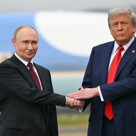 President Donald Trump greets Russian President Vladimir Putin on the tarmac after they arrived at Joint Base Elmendorf-Richardson in Anchorage, Alaska, on Aug. 15, 2025.