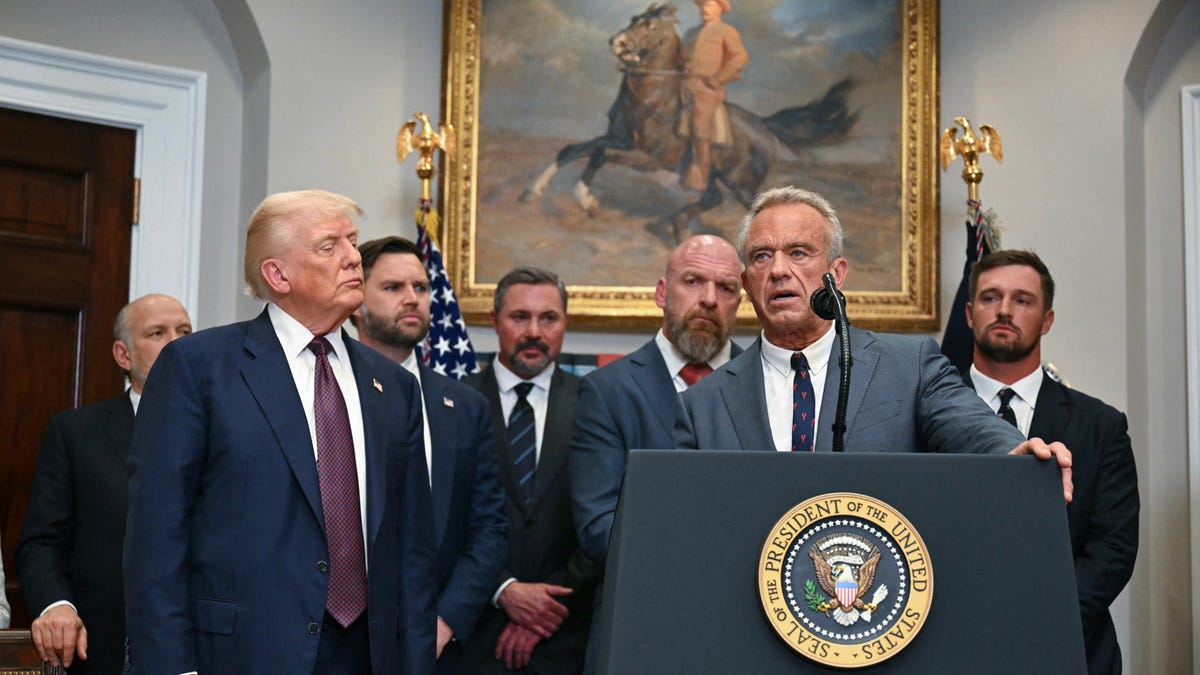 US President Donald Trump (2L) listens as US Secretary of Health and Human Services Robert F. Kennedy Jr. speaks prior to signing an executive order restarting the Presidential Fitness Test in public schools in the Roosevelt Room of the White House in Washington, DC, on July 31, 2025. (Photo by Jim WATSON / AFP) (Photo by JIM WATSON/AFP via Getty Images)