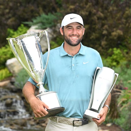 Aug. 17: Scottie Scheffler poses with the J. K. Wadley Trophy and The Keeper after winning the BMW Championship golf tournament at Caves Valley Golf Club in Owings Mills, Maryland.