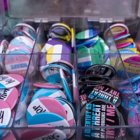 Transgender flag and pronoun buttons are seen for sale during 2025 PrideFest in Des Moines.