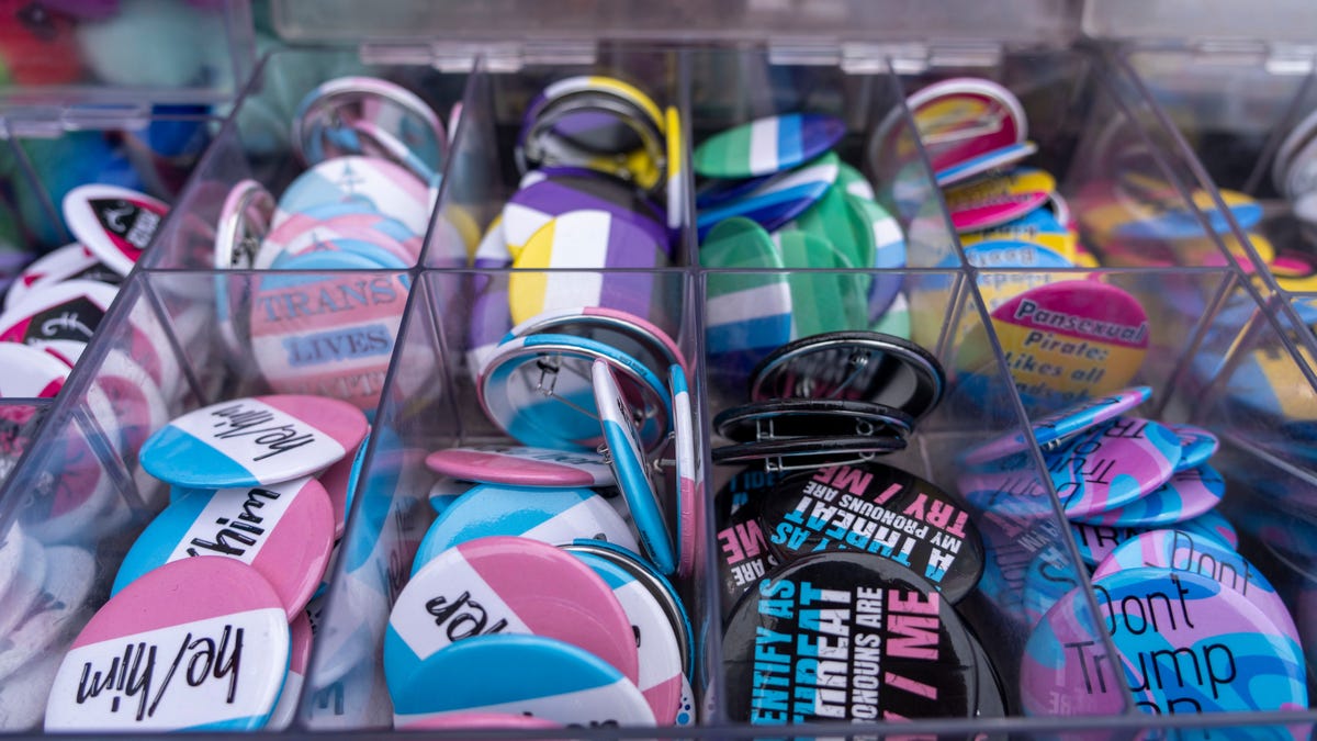 Transgender flag and pronoun buttons are seen for sale during 2025 PrideFest in Des Moines.