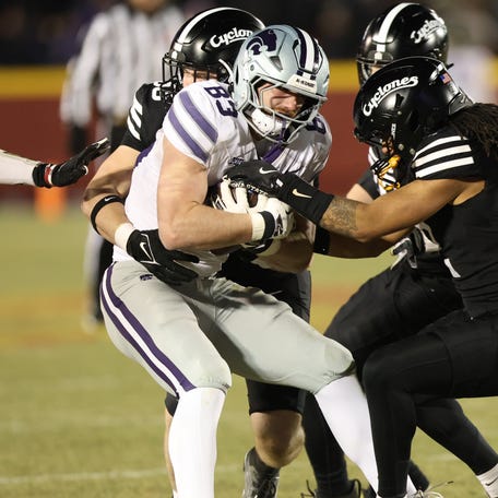 Kansas State tight end Will Swanson (83) is tackled by the Iowa State defense during their 2024 game at Jack Trice Stadium.