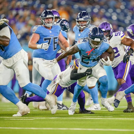 Tennessee Titans running back Jordan Mims (24) is stopped by Minnesota Vikings safety Mishael Powell (40) during the fourth quarter of an NFL pre-season game at Nissan Stadium in Nashville, Tenn., Friday, Aug. 22, 2025.