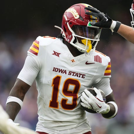 Iowa State defender Ta'Shawn James celebrates a fumble recovery with teammate Will McLaughlin during their game against Kansas State at Aviva Stadium in Dublin, Ireland.