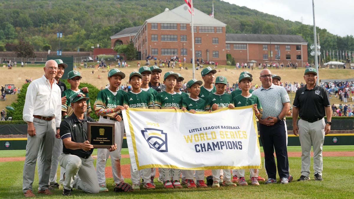 Aug 24, 2025; Williamsport, PA, USA; Asia-Pacific Region pose with the championship banner after the game against Mountain Region at Howard J. Lamade Stadium. Mandatory Credit: Kyle Ross-Imagn Images