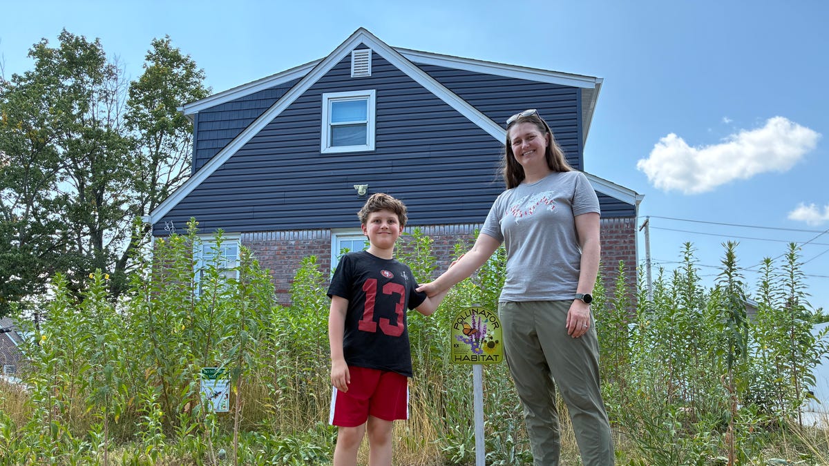 Aimee Kemp, right, and her son, Auron, have transformed their yard into a native plant garden. While it helps to restore native habitats, their yard has faced violations by their Long Island village government for being "unsightly."