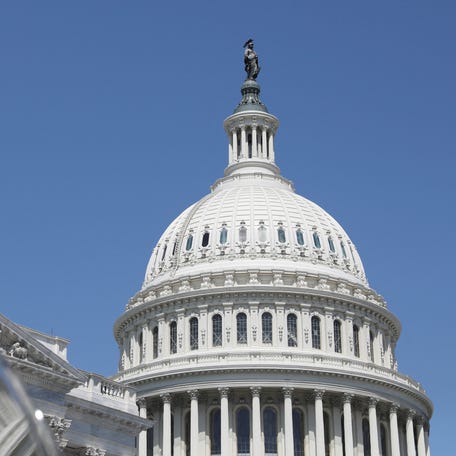 The dome of the U.S. Capitol is reflected in a window on Capitol Hill in Washington, U.S., April 20, 2023.