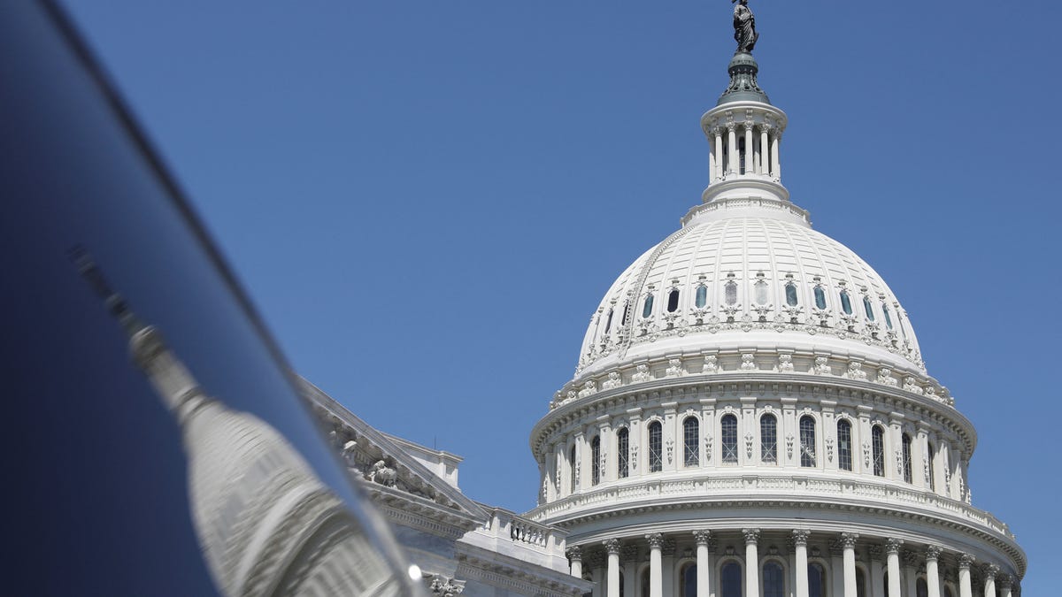The dome of the U.S. Capitol is reflected in a window on Capitol Hill in Washington, U.S., April 20, 2023.