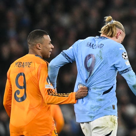 Real Madrid's French forward #09 Kylian Mbappe (L) pull sthe jersey of Manchester City's Norwegian striker #09 Erling Haaland during the UEFA Champions League football match between Manchester City and Real Madrid at the Etihad Stadium in Manchester, north west England, on February 11, 2025. (Photo by Oli SCARFF / AFP) (Photo by OLI SCARFF/AFP via Getty Images)