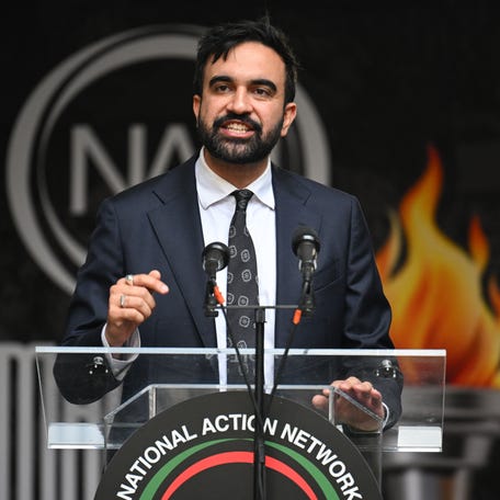 With the Rev. Al Sharpton, founder and president of the National Action Network, New York City Mayoral candidate Zohran Mamdani addresses a "March on Wall Street" to call for economic justice on Aug. 28, 2025.