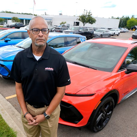 Tim Brown, a sales consultant and EV specialist at Feldman Chevrolet in Novi, stands in front of a row of Chevrolet Equinox EV's on Friday, August 29, 2025.   The EV clean vehicle tax credit on vehicles like the Equinox EV that qualifies expires on September 30, 2025..