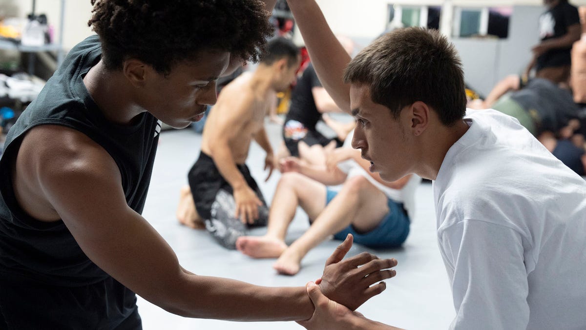 Arthur Espinoza (right) grapples with another young man at Super MMA Gym in Fontana, Calif., on June 24, 2025.