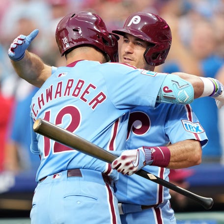 Aug 28, 2025; Philadelphia, Pennsylvania, USA; Philadelphia Phillies designated hitter Kyle Schwarber (12) reacts with catcher J.T. Realmuto (10) after hitting a home run against the Atlanta Braves in the first inning at Citizens Bank Park. Mandatory Credit: Kyle Ross-Imagn Images