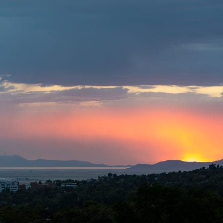 The sun sets over the Great Salt Lake and Salt Lake City.
