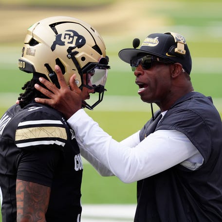 Colorado head coach Deion Sanders congratulates quarterback Kaidon Salter following a touchdown pass in the first quarter against Georgia Tech.